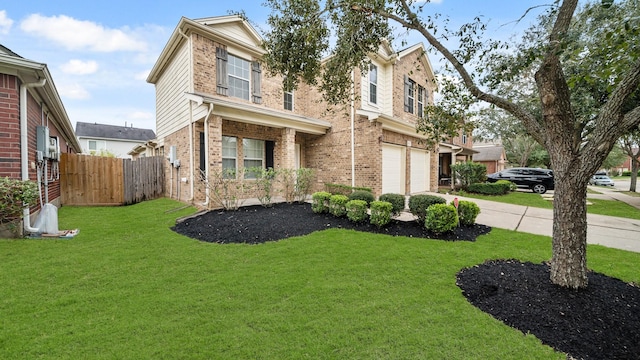 view of front of property featuring a front yard and a garage