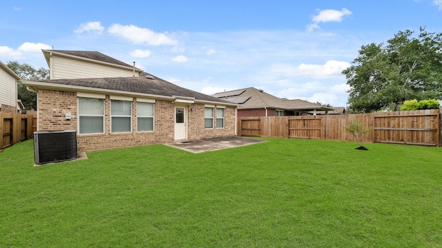 back of house with a lawn, central AC, and a patio