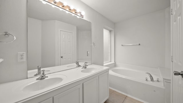 bathroom with a bathtub, vanity, and tile patterned flooring