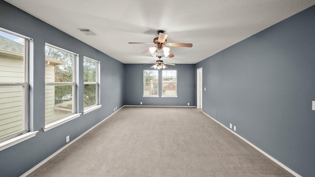 spare room featuring light carpet and ceiling fan