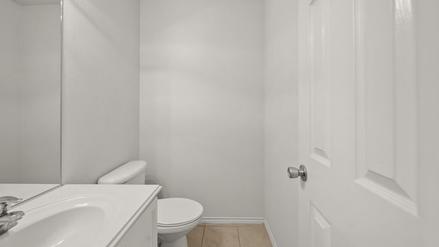 bathroom featuring tile patterned floors, vanity, and toilet