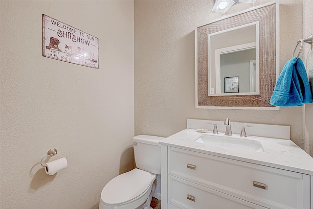 bathroom featuring toilet and vanity