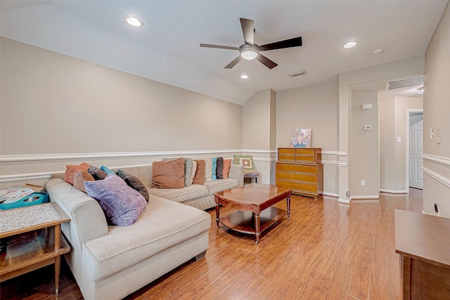 living room featuring lofted ceiling, ceiling fan, and hardwood / wood-style flooring