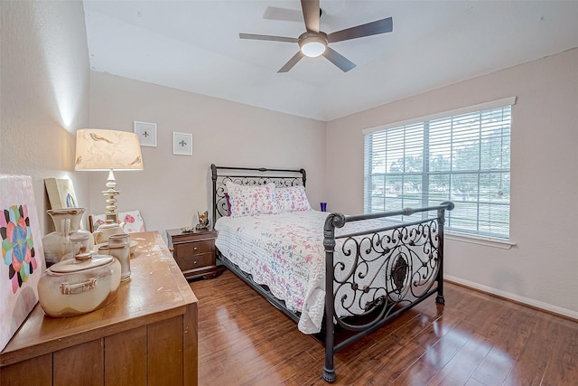 bedroom with ceiling fan and dark hardwood / wood-style floors