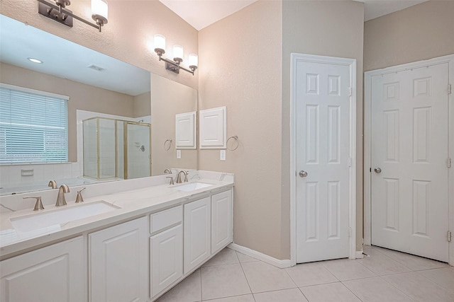 bathroom with vanity, tile patterned flooring, and a shower with door