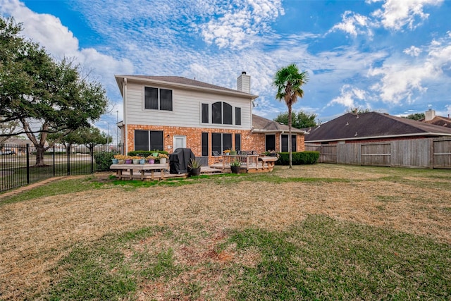 rear view of house featuring a yard