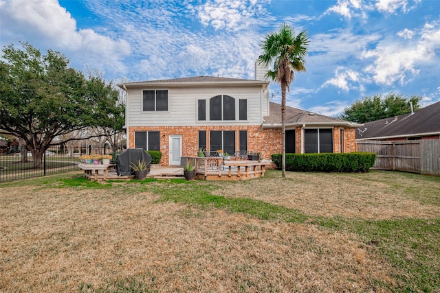 back of house with a deck and a yard