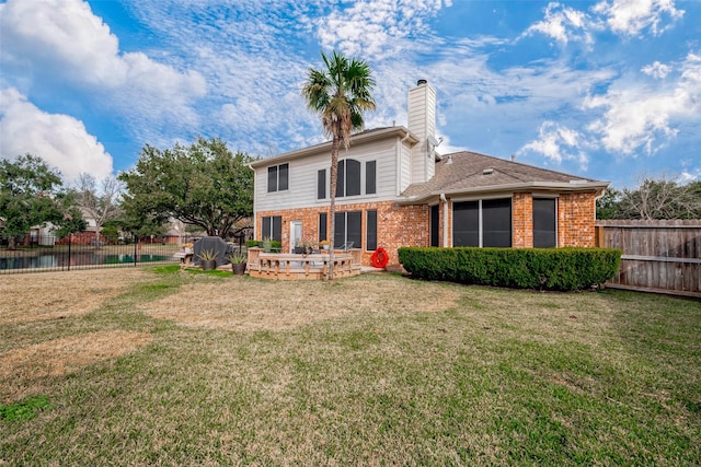 rear view of house featuring a yard