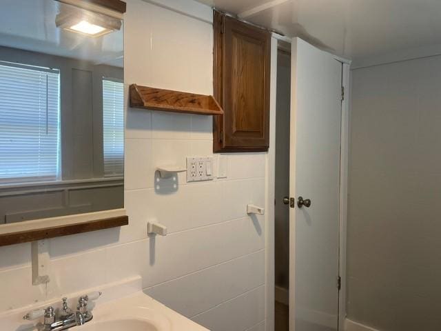 bathroom featuring vanity and backsplash