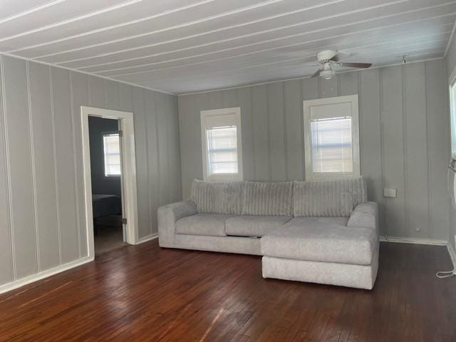 unfurnished living room with dark hardwood / wood-style flooring and ceiling fan