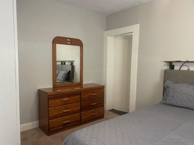 bedroom featuring light colored carpet