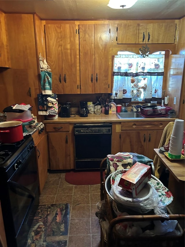 kitchen with black appliances, brown cabinetry, and light countertops