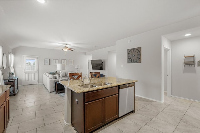 kitchen with ceiling fan, sink, stainless steel dishwasher, an island with sink, and light tile patterned floors