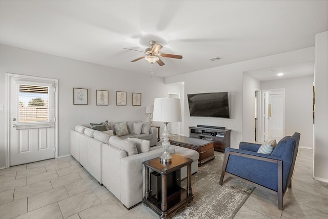 living room featuring light tile patterned floors and ceiling fan