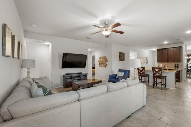 living room featuring ceiling fan and light tile patterned floors