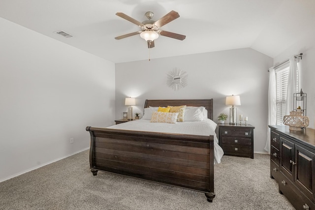 carpeted bedroom with ceiling fan and vaulted ceiling