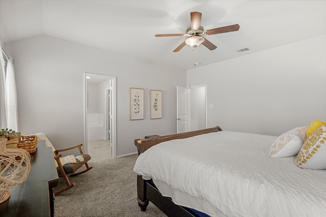 carpeted bedroom with ceiling fan, lofted ceiling, and ensuite bath