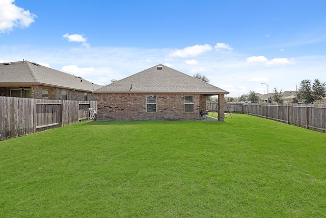 back of house with a yard