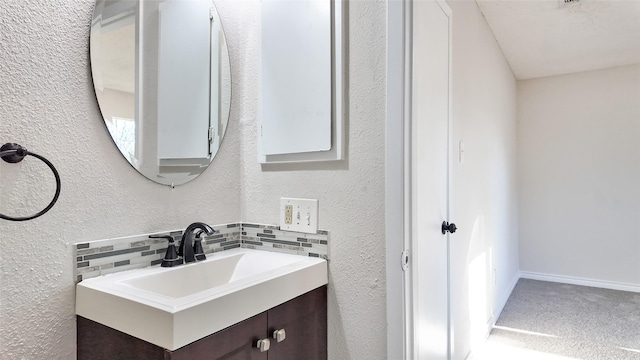 bathroom with decorative backsplash and vanity