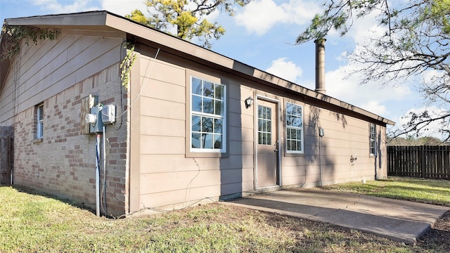 view of side of home with a lawn