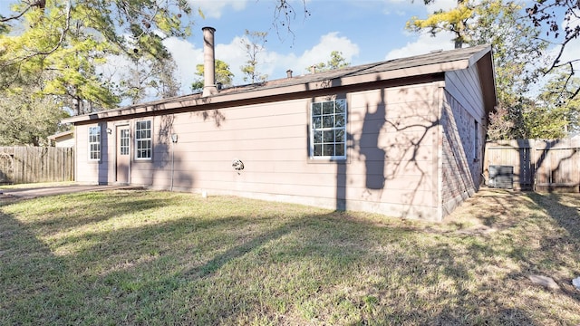 rear view of property with a lawn