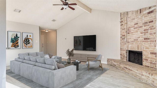 living room featuring ceiling fan, light hardwood / wood-style floors, a fireplace, and lofted ceiling with beams