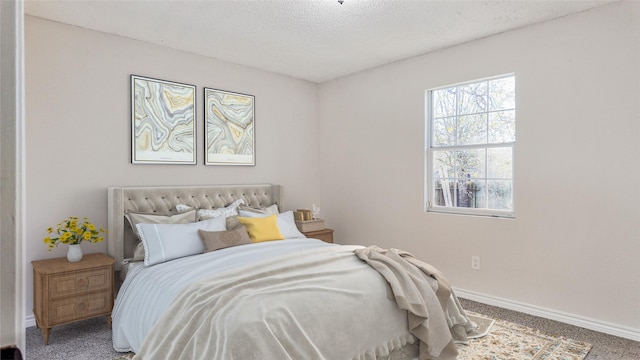 bedroom featuring a textured ceiling and carpet floors