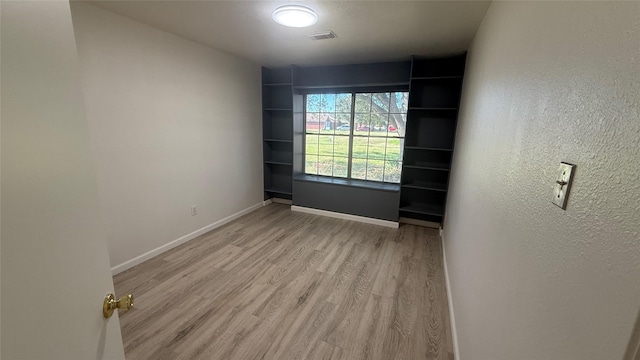 unfurnished room with light hardwood / wood-style floors