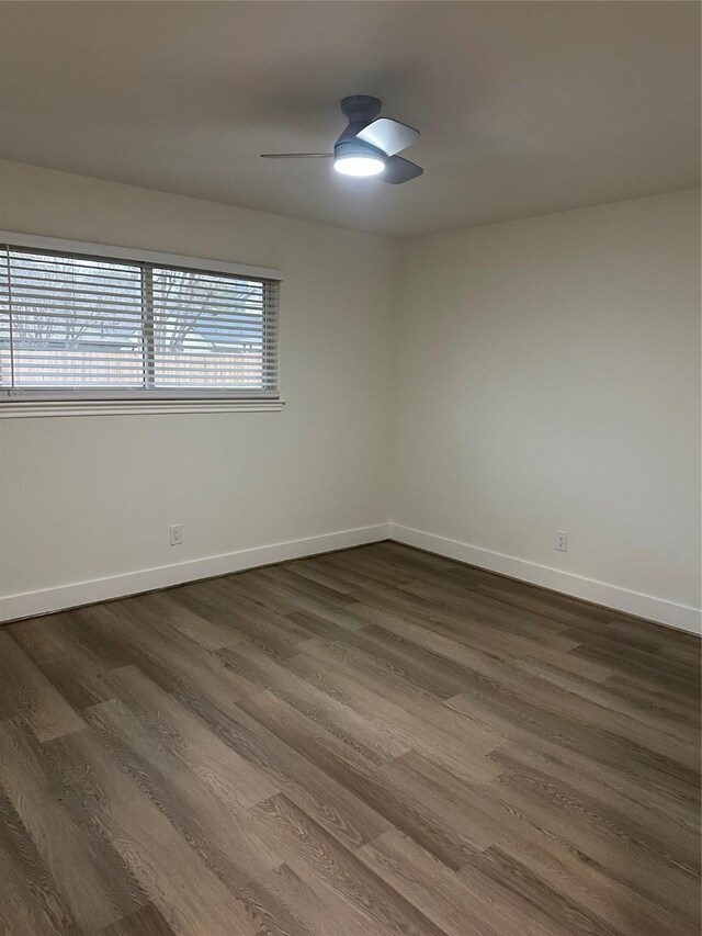 empty room featuring dark hardwood / wood-style flooring, ceiling fan, and a healthy amount of sunlight