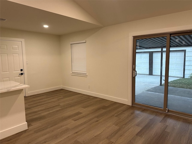 interior space featuring dark hardwood / wood-style floors and lofted ceiling