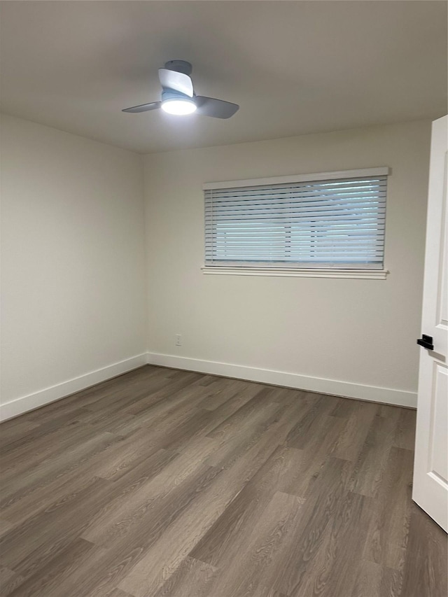 spare room featuring ceiling fan and dark hardwood / wood-style floors