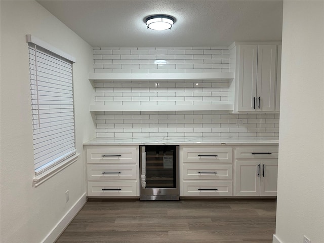 kitchen with white cabinets, decorative backsplash, dark wood-type flooring, and wine cooler