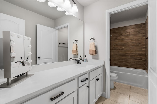 full bathroom featuring tile patterned flooring, vanity, tiled shower / bath, and toilet