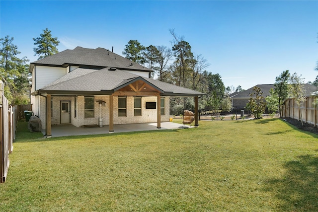 back of house with a yard and a patio area