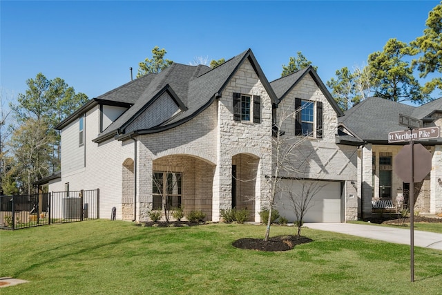 view of front of property with a garage and a front lawn