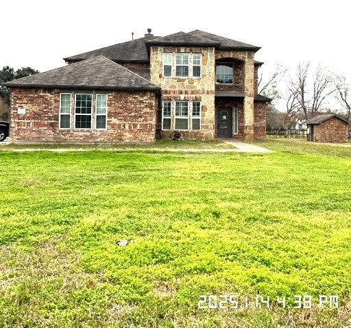 rear view of property with a lawn