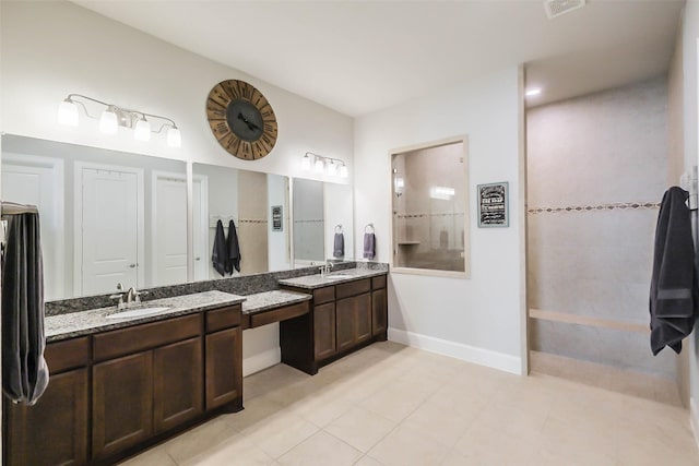 bathroom featuring tile patterned flooring and vanity