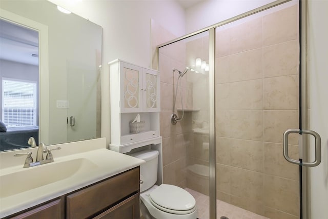 bathroom with vanity, an enclosed shower, and toilet