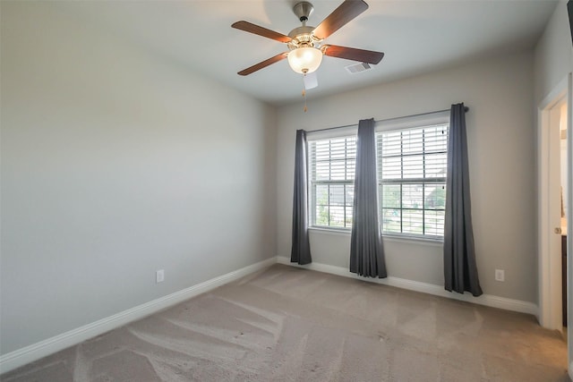 spare room featuring ceiling fan and light colored carpet