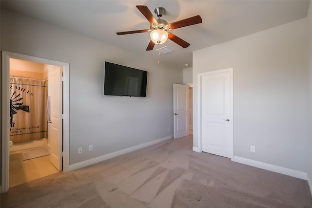 unfurnished bedroom featuring ensuite bath, ceiling fan, and carpet