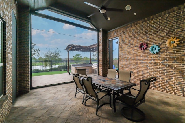 view of patio with area for grilling, ceiling fan, and a water view