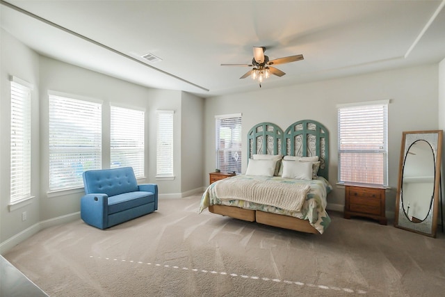 bedroom featuring multiple windows, ceiling fan, and carpet floors