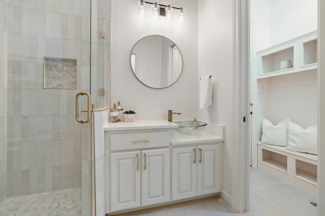 bathroom with tile patterned flooring, vanity, and a shower with shower door