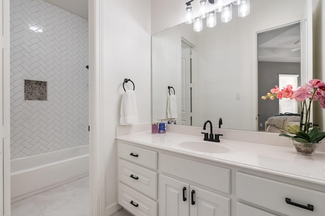 bathroom with vanity and tiled shower / bath