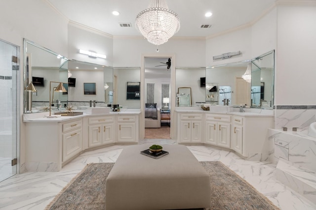 bathroom with vanity, ceiling fan with notable chandelier, a shower with door, and crown molding