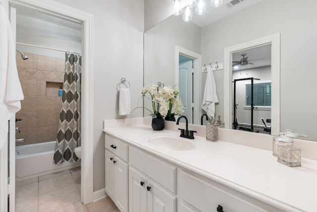 full bathroom featuring vanity, tile patterned floors, ceiling fan, toilet, and shower / bath combo with shower curtain