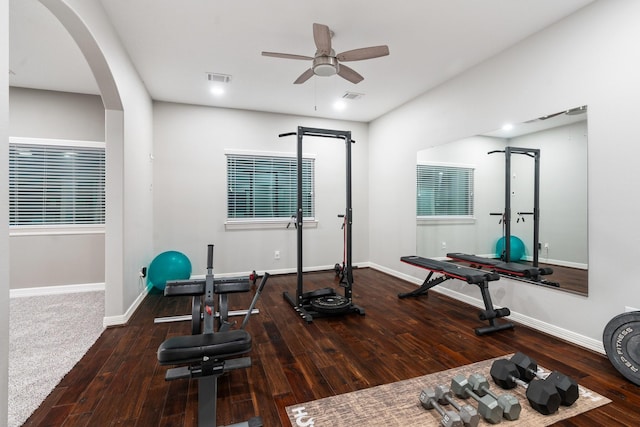 workout area featuring ceiling fan and dark hardwood / wood-style floors