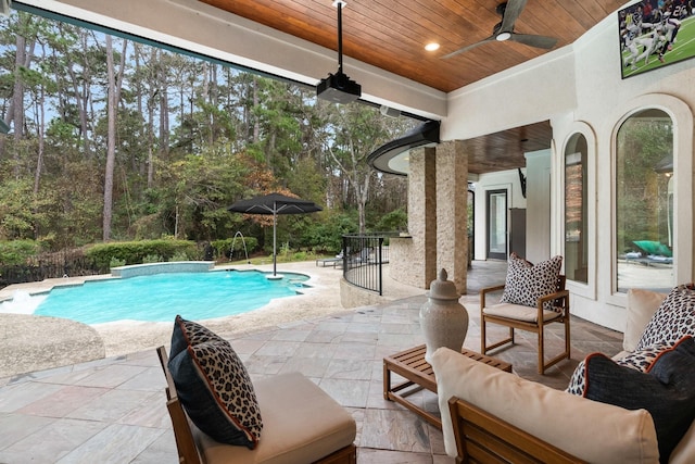 view of pool featuring ceiling fan and a patio