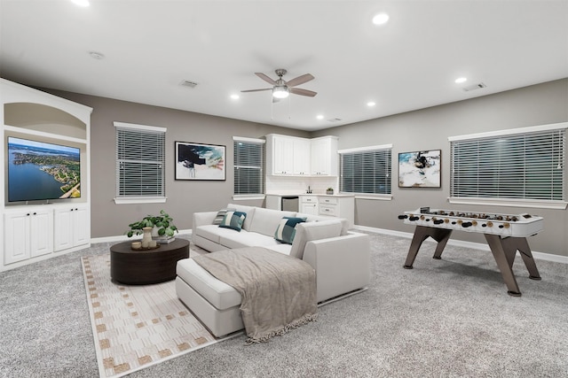 living room with ceiling fan and light carpet