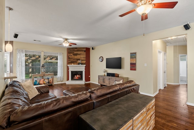 living room featuring ceiling fan and dark hardwood / wood-style flooring